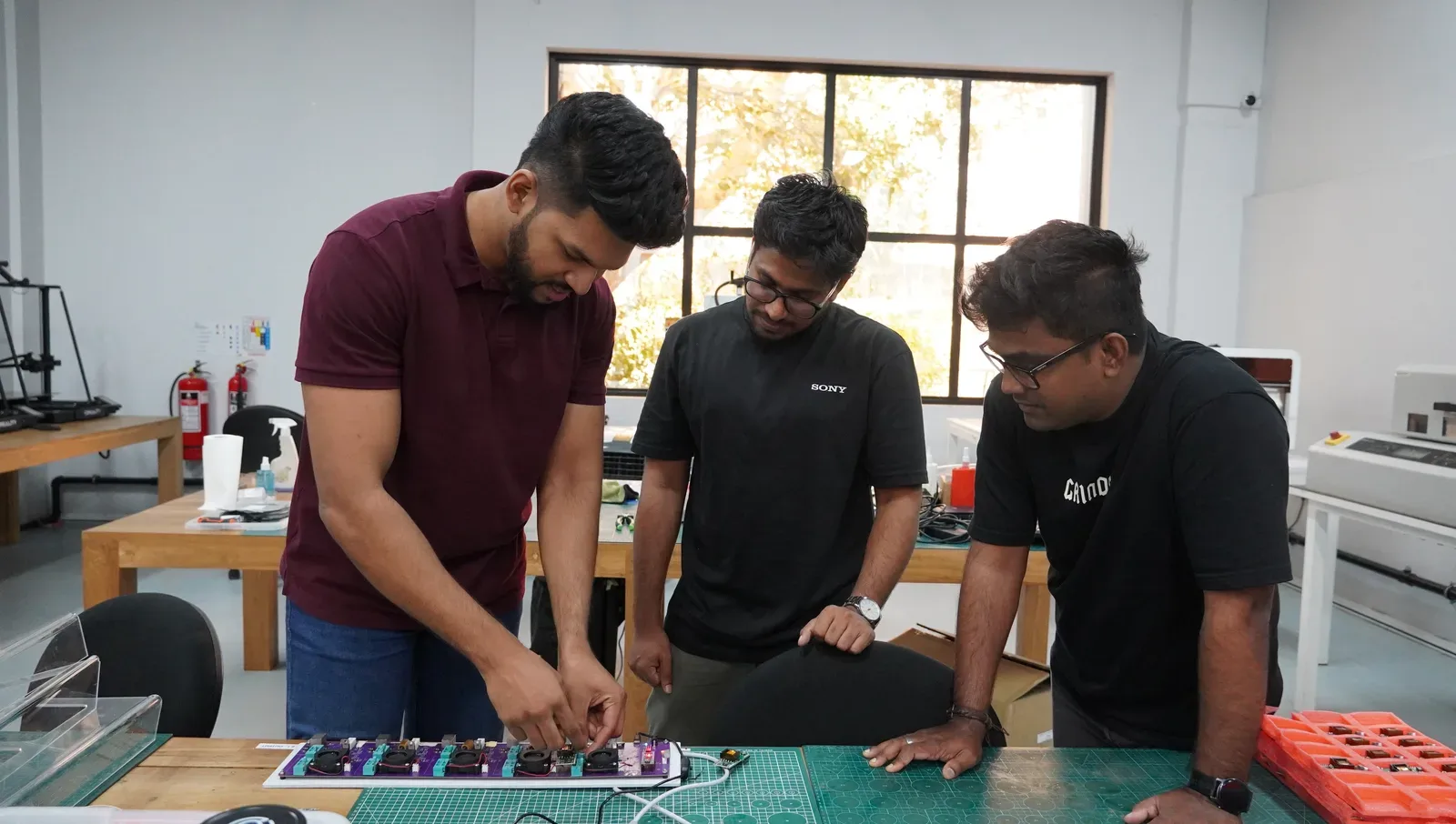 Atlas Labs product engineers reviewing an electronics prototype