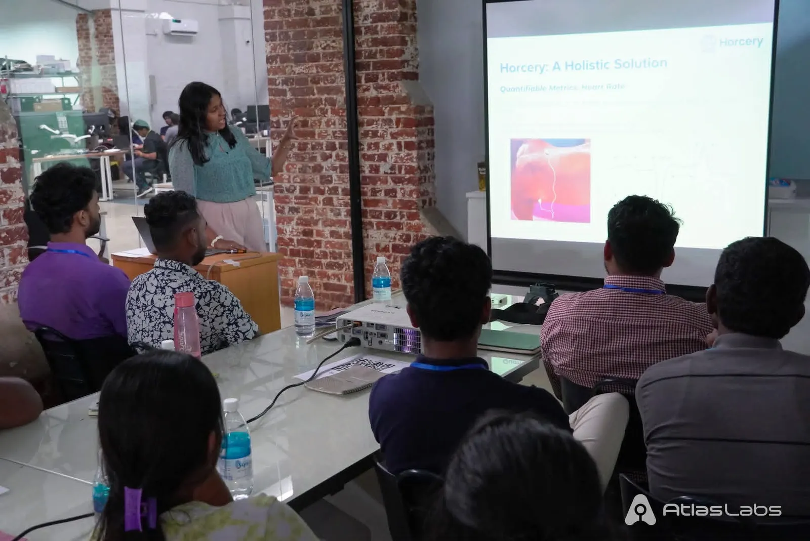 Atlas Labs colleagues attending a presentation
