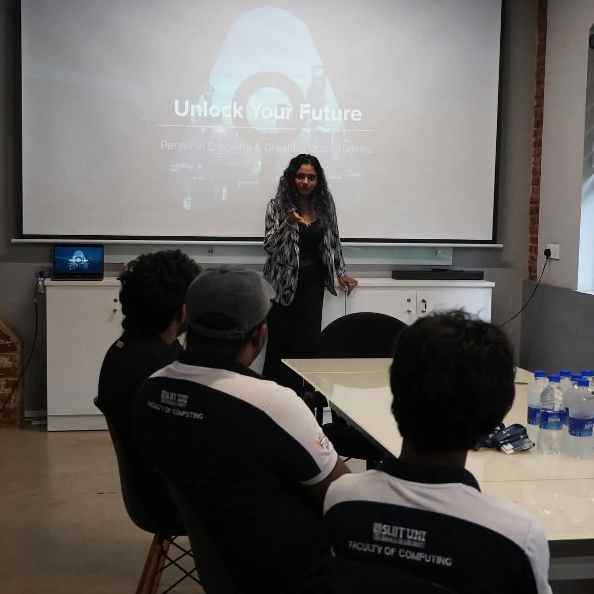 A speaker presenting to colleagues
